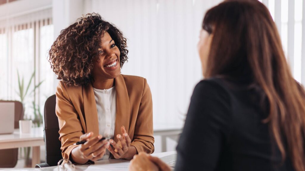 A brand consultant happily chats with a prospective client.